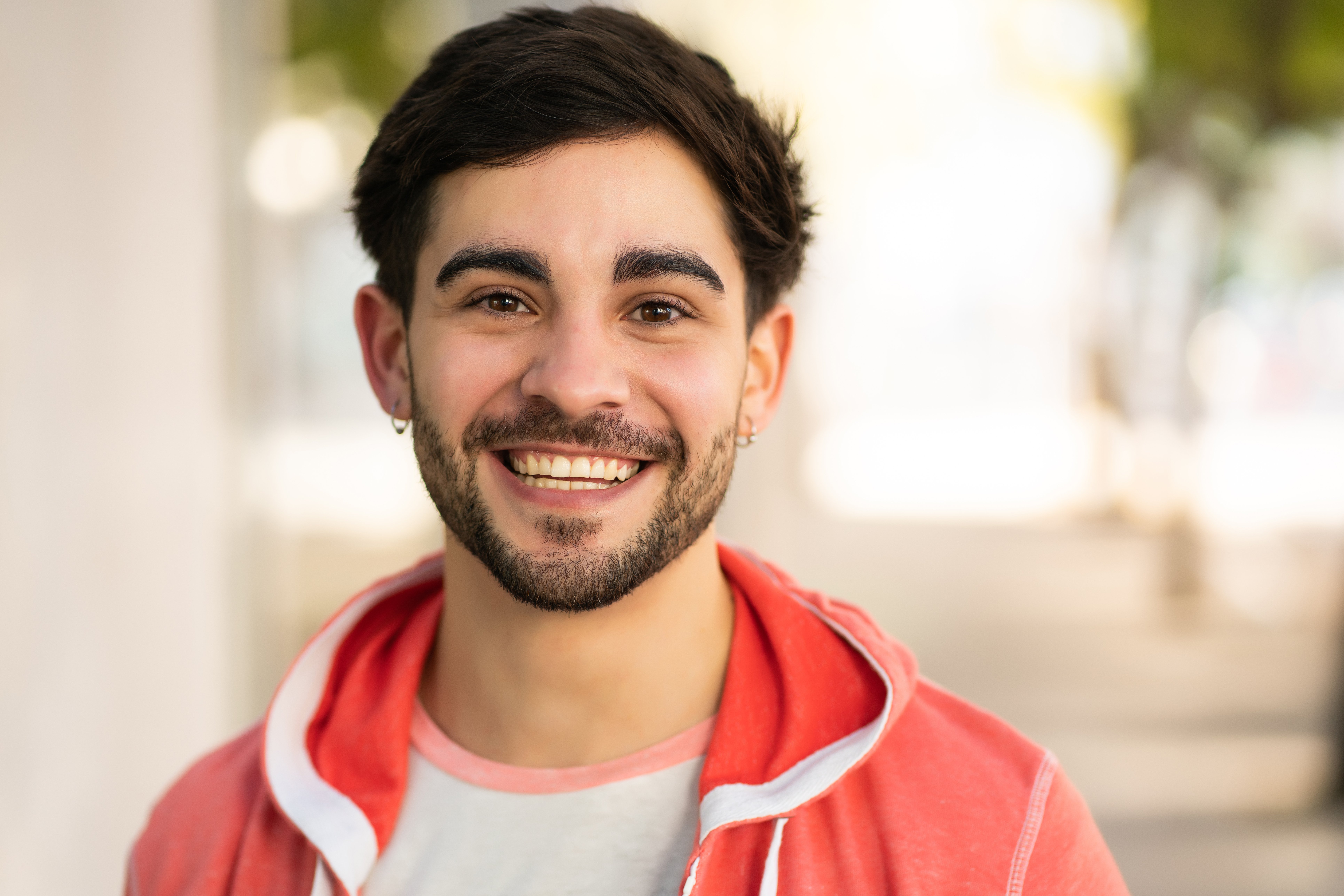 close-up-of-young-man-smiling-outdoors-2024-10-18-05-40-03-utc